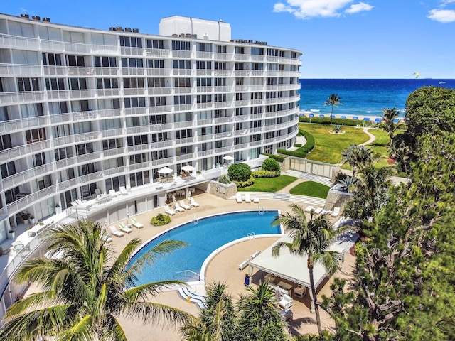 view of pool featuring a patio and a water view