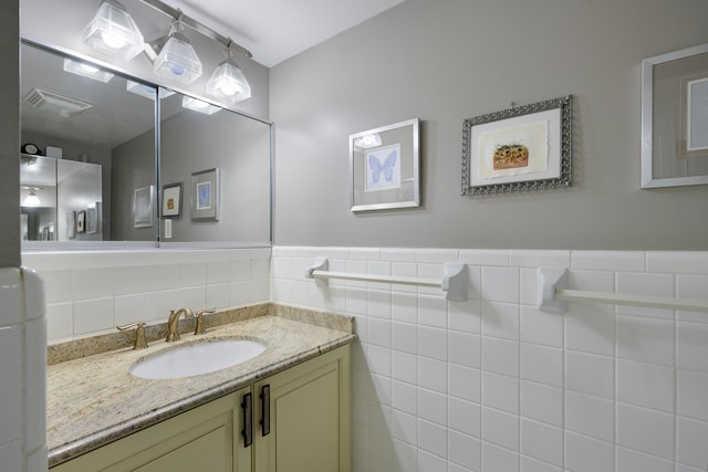 bathroom with backsplash, oversized vanity, and tile walls