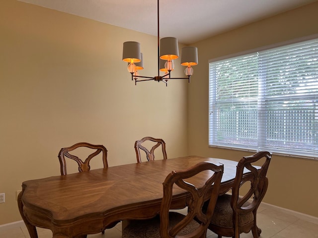 dining room featuring light tile patterned floors and a notable chandelier