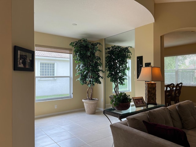 living room featuring light tile patterned flooring and a healthy amount of sunlight