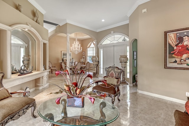 interior space featuring decorative columns, a notable chandelier, and ornamental molding