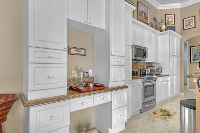 kitchen with stone countertops, appliances with stainless steel finishes, light tile flooring, and white cabinetry