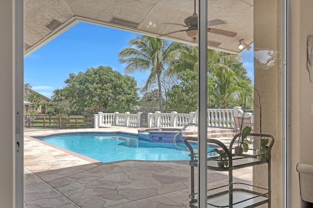 view of swimming pool featuring a patio and an in ground hot tub