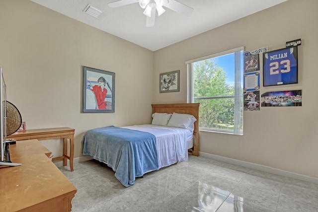 tiled bedroom featuring ceiling fan