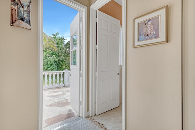 doorway to outside featuring light tile floors