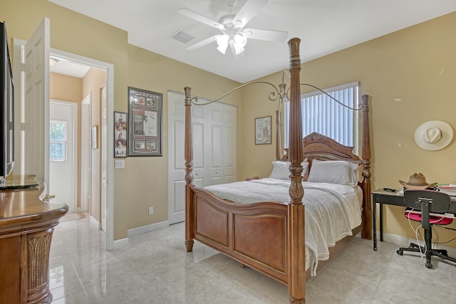 bedroom featuring a closet, ceiling fan, and light tile floors