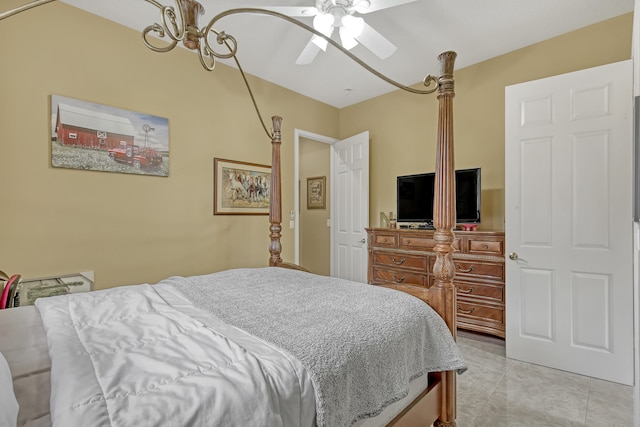 tiled bedroom featuring ceiling fan