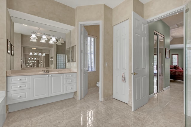 bathroom featuring toilet, tile flooring, and vanity