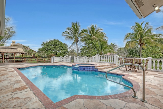 view of swimming pool with a gazebo, an in ground hot tub, and a patio