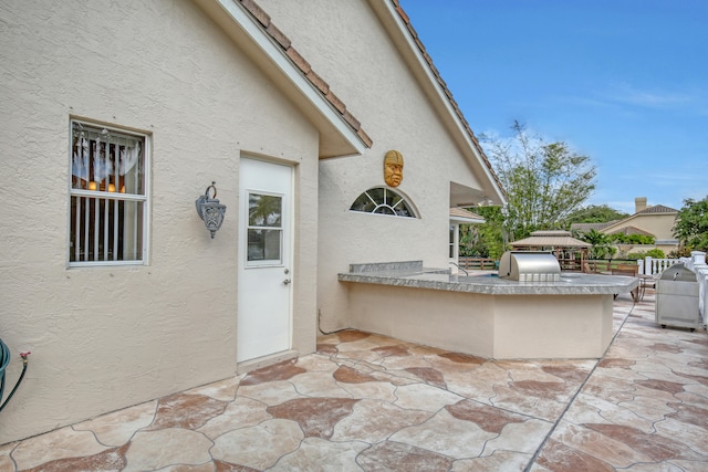 view of patio with exterior kitchen and grilling area