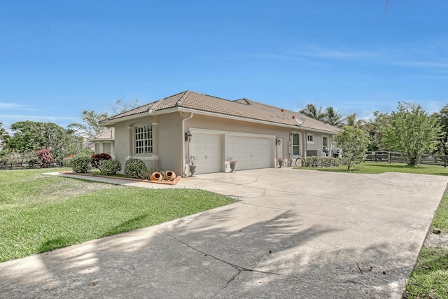 ranch-style home featuring a garage and a front lawn