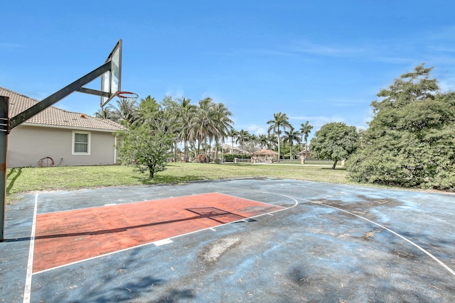 view of basketball court with a lawn