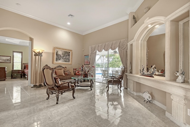 sitting room featuring ornamental molding and light tile floors