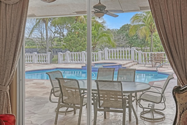 view of swimming pool with a patio and an in ground hot tub