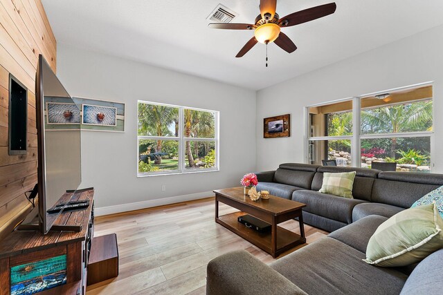 living room with ceiling fan and light wood-type flooring