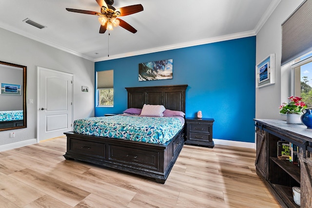 bedroom with ornamental molding, ceiling fan, and light hardwood / wood-style flooring