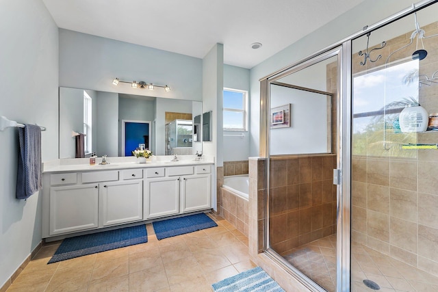 bathroom featuring tile patterned floors, vanity, and shower with separate bathtub