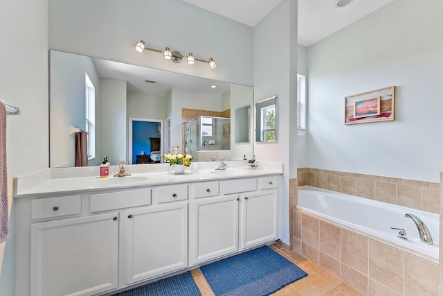 bathroom with tile patterned flooring, shower with separate bathtub, plenty of natural light, and vanity