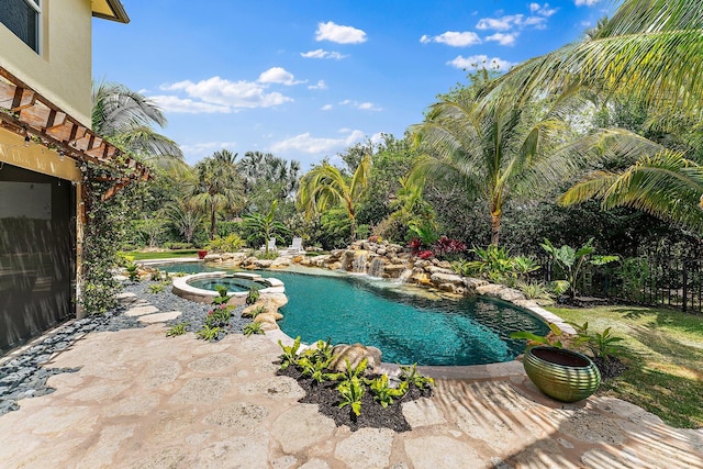 view of pool with an in ground hot tub