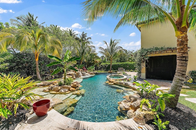 view of swimming pool with an in ground hot tub