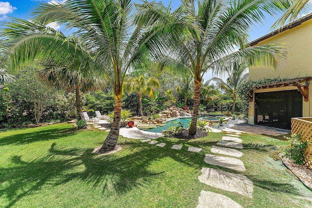 view of yard featuring a swimming pool with hot tub