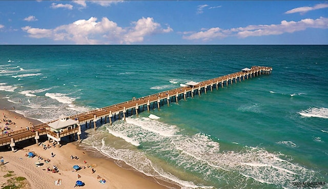 exterior space featuring a water view and a beach view