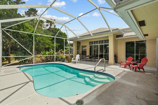 view of swimming pool with a patio area and a lanai