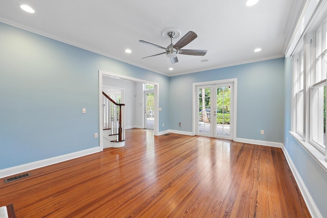 spare room featuring ceiling fan, light wood-type flooring, french doors, and ornamental molding