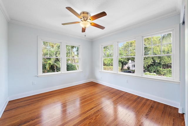 unfurnished room with ceiling fan, a textured ceiling, hardwood / wood-style flooring, and ornamental molding