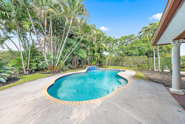 view of swimming pool with a patio and pool water feature