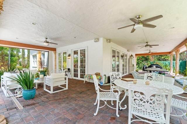 view of patio featuring french doors and ceiling fan