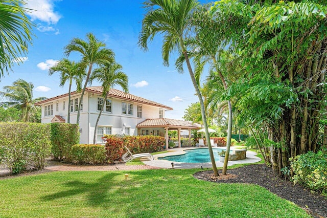 view of swimming pool featuring a patio and a yard