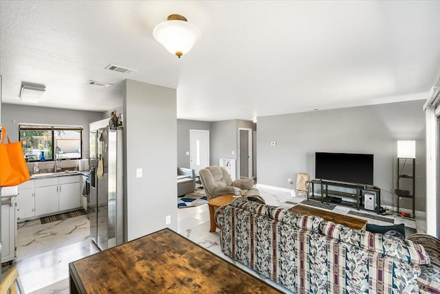 living room with sink and light tile flooring