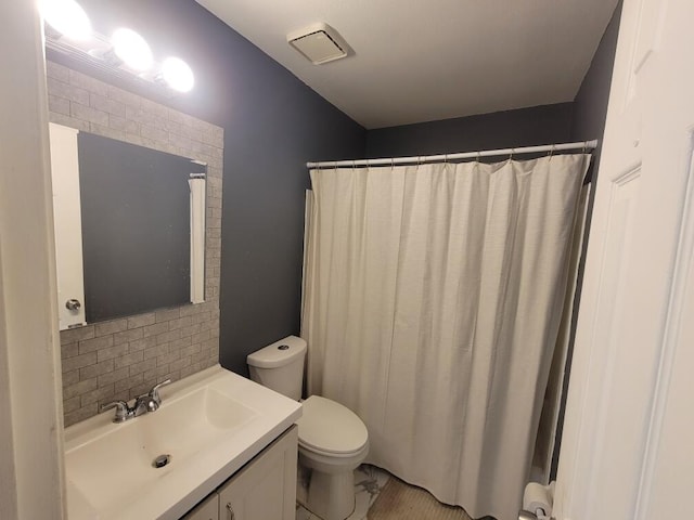 bathroom with vanity with extensive cabinet space and toilet