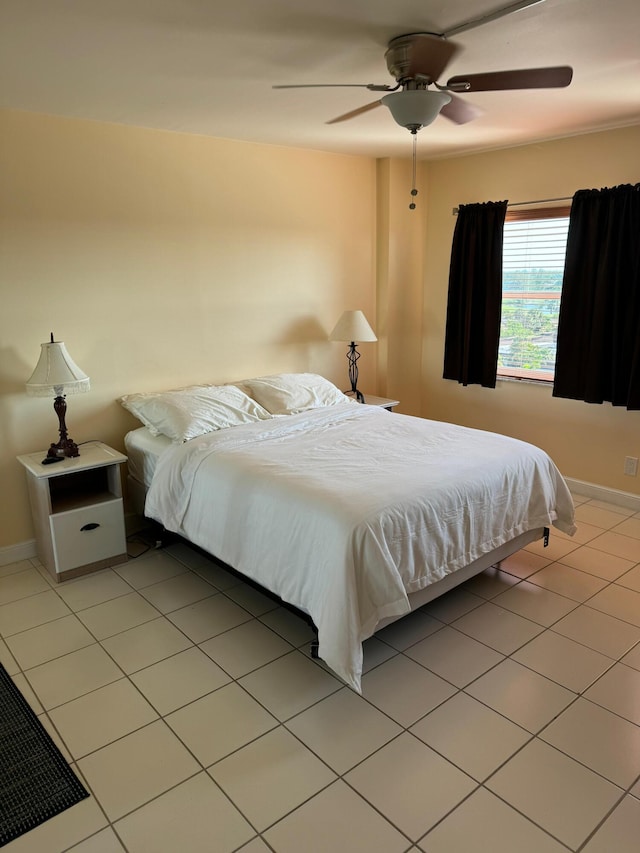 bedroom with ceiling fan and light tile patterned flooring