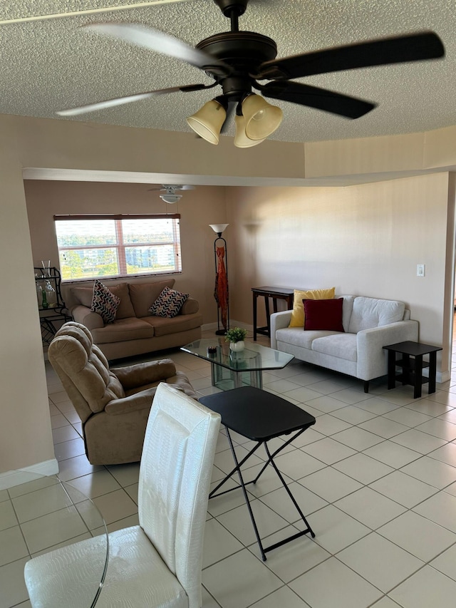 tiled living room featuring ceiling fan and a textured ceiling