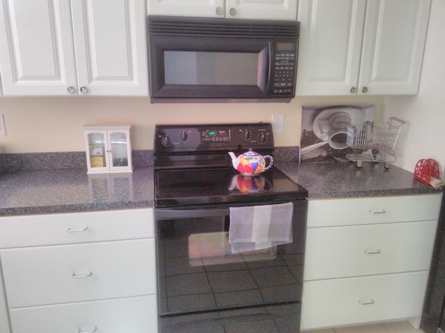 kitchen featuring white cabinets and black appliances