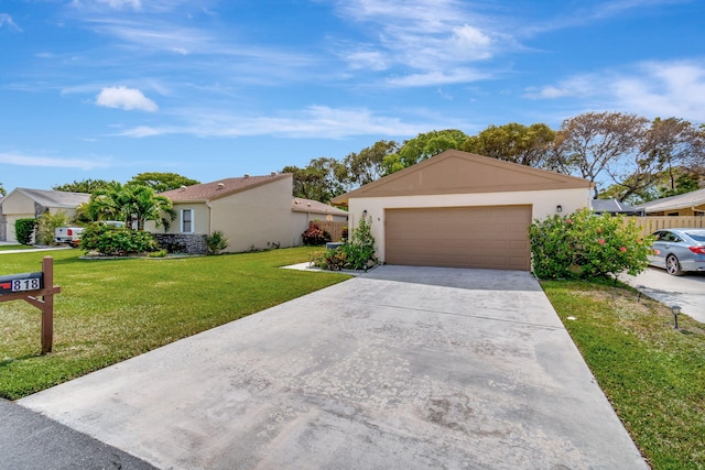 single story home featuring a garage and a front lawn