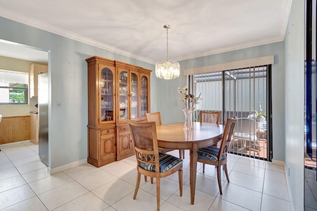 tiled dining room featuring a chandelier and crown molding