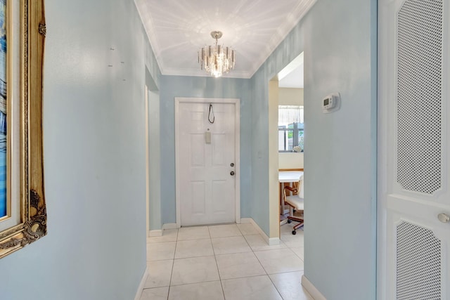 foyer featuring light tile patterned floors, an inviting chandelier, and crown molding