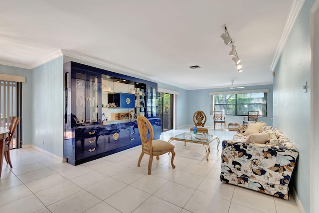 tiled living room with crown molding, rail lighting, and ceiling fan