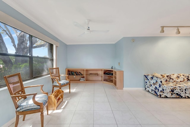 living area featuring crown molding, ceiling fan, light tile patterned flooring, and rail lighting