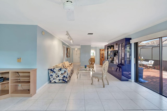 tiled living room featuring track lighting, ceiling fan, and crown molding