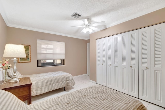 bedroom featuring a textured ceiling, ceiling fan, crown molding, and light tile patterned flooring