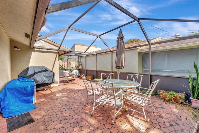 view of patio / terrace featuring a lanai