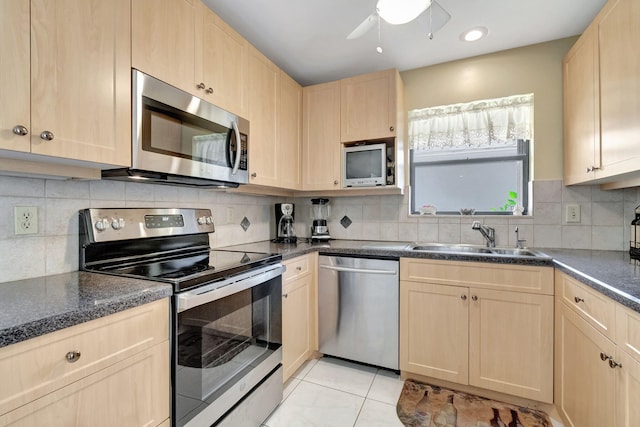 kitchen with light brown cabinetry, sink, and appliances with stainless steel finishes