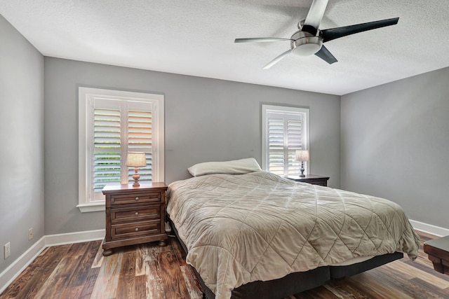 bedroom with a textured ceiling, ceiling fan, and dark hardwood / wood-style flooring