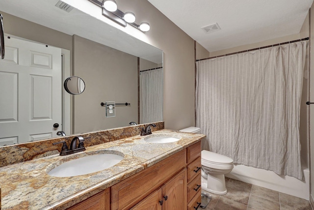 full bathroom with tile flooring, double sink, shower / tub combo with curtain, vanity with extensive cabinet space, and toilet