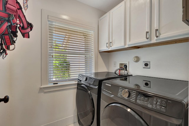 clothes washing area featuring washer and dryer, cabinets, hookup for a washing machine, and hookup for an electric dryer