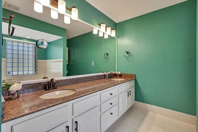 bathroom with tile flooring and double vanity